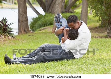 Stock Photo - fort lauderdale, florida, united states of america; a father playing with his young son. Fotosearch