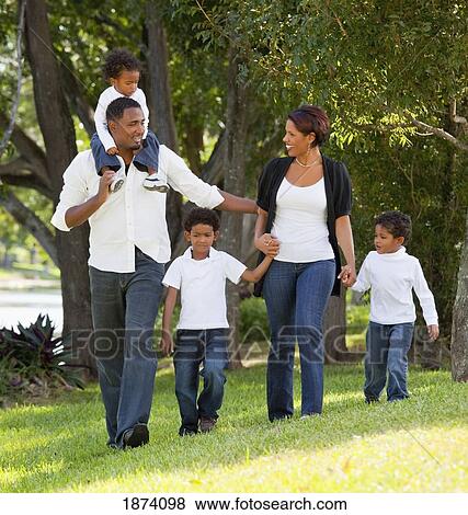 Stock Photo - fort lauderdale, florida, united states of america; a family walking in a park. Fotosearch