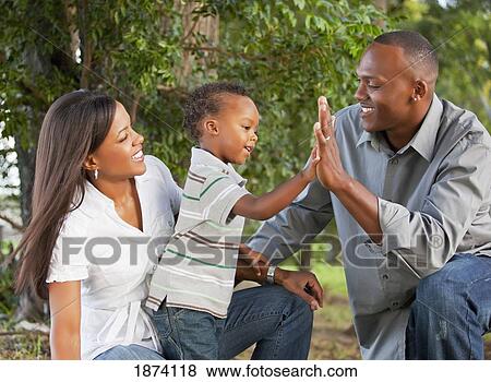 Stock Photo - fort lauderdale, florida, united states of america; a father and mother with their young son. Fotosearch