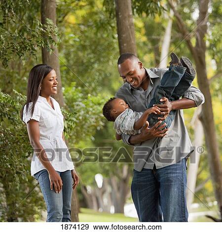 fort lauderdale, florida, united states of america; a father playing with his young son while the mother watches View Large Photo Image Stock Photo - fort lauderdale, florida, united states of america; a father playing with his young son while the mother watches. Fotosearch