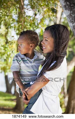 Stock Photo - fort lauderdale, florida, united states of america; a mother holding her young son. Fotosearch