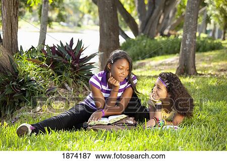 fort lauderdale, florida, united states of america; two teenage girls talking in the park with a bible View Large Photo Image Stock Photo - fort lauderdale, florida, united states of america; two teenage girls talking in the park with a bible. Fotosearch