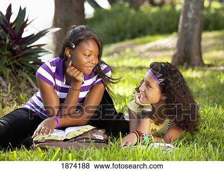 fort lauderdale, florida, united states of america; two teenage girls talking in the park with their school books View Large Photo Image Stock Photo - fort lauderdale, florida, united states of america; two teenage girls talking in the park with their school books. Fotosearch