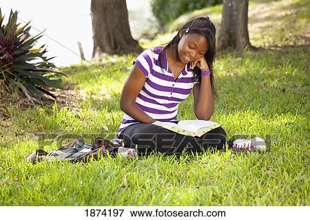 fort lauderdale, florida, united states of america; a teenage girl reading a bible in the park View Large Photo Image Stock Photo - fort lauderdale, florida, united states of america; a teenage girl reading a bible in the park. Fotosearch