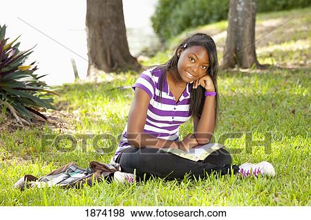fort lauderdale, florida, united states of america; a teenage girl reading a bible in the park View Large Photo Image Stock Photo - fort lauderdale, florida, united states of america; a teenage girl reading a bible in the park. Fotosearch