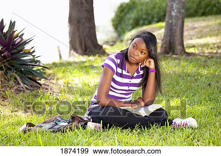 fort lauderdale, florida, united states of america; a teenage girl reading a bible in the park View Large Photo Image Stock Photo - fort lauderdale, florida, united states of america; a teenage girl reading a bible in the park. Fotosearch