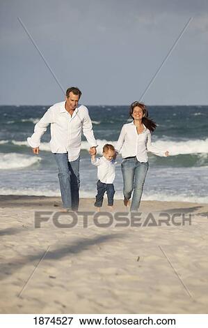Stock Photo - fort lauderdale, florida, united states of america; a family running on the beach. Fotosearch