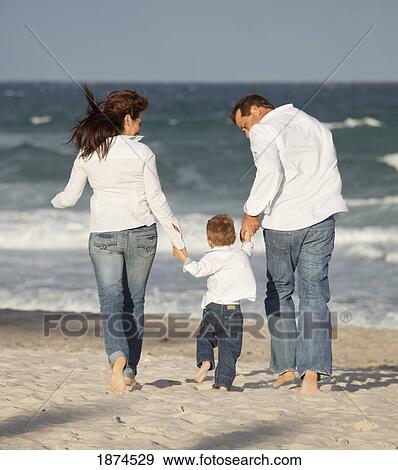 Stock Photo - fort lauderdale, florida, united states of america; a family walking on the beach. Fotosearch