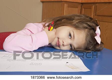 Stock Photograph - fort lauderdale, florida, united states of america; a young girl coloring at a table. Fotosearch
