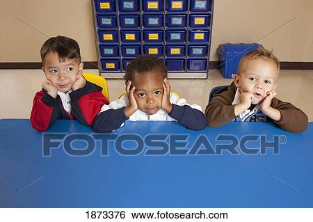 fort lauderdale, florida, united states of america; three young boys sitting at a table in a classroom View Large Photo Image Stock Photograph - fort lauderdale, florida, united states of america; three young boys sitting at a table in a classroom. Fotosearch