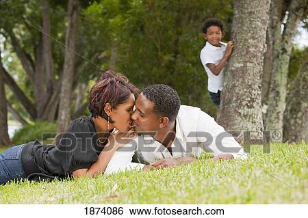 fort lauderdale, florida, united states of america; a couple kissing while their son watches View Large Photo Image Stock Photograph - fort lauderdale, florida, united states of america; a couple kissing while their son watches. Fotosearch