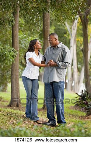 Stock Photograph - fort lauderdale, florida, united states of america; a couple walking through a park. Fotosearch