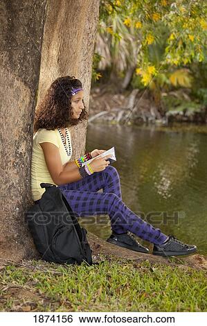 fort lauderdale, florida, united states of america; a girl reading a book under a tree View Large Photo Image Stock Photograph - fort lauderdale, florida, united states of america; a girl reading a book under a tree. Fotosearch