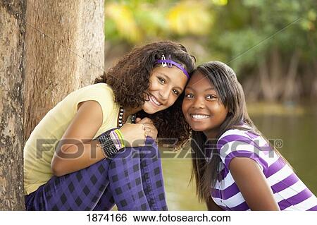 Stock Photograph - fort lauderdale, florida, united states of america; two teenage girls in a park. Fotosearch