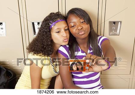 fort lauderdale, florida, united states of america; two teenage girls sitting in a school hallway taking a picture of themselves View Large Photo Image Stock Photograph - fort lauderdale, florida, united states of america; two teenage girls sitting in a school hallway taking a picture of themselves. Fotosearch