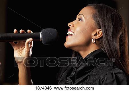 fort lauderdale, florida, united states of america; a woman singing in a microphone View Large Photo Image Stock Photograph - fort lauderdale, florida, united states of america; a woman singing in a microphone. Fotosearch