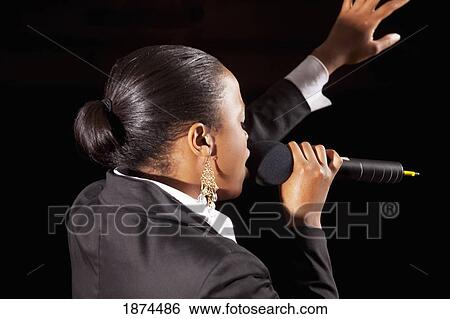 fort lauderdale, florida, united states of america; a woman singing into a microphone and leading worship View Large Photo Image Stock Photograph - fort lauderdale, florida, united states of america; a woman singing into a microphone and leading worship. Fotosearch