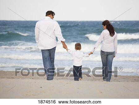 Stock Photograph - fort lauderdale, florida, united states of america; a family walking on the beach by the ocean. Fotosearch