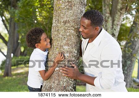 fort lauderdale, florida, united states of america; a father and son playing by a tree View Large Photo Image Stock Photography - fort lauderdale, florida, united states of america; a father and son playing by a tree. Fotosearch