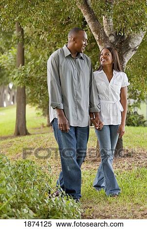 Stock Photography - fort lauderdale, florida, united states of america; a couple walking through a park. Fotosearch