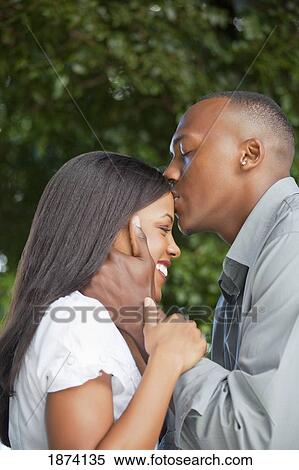 Stock Photography - fort lauderdale, florida, united states of america; a man kissing a woman's forehead. Fotosearch