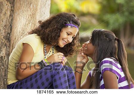 fort lauderdale, florida, united states of america; two teenage girls telling secrets View Large Photo Image Stock Photography - fort lauderdale, florida, united states of america; two teenage girls telling secrets. Fotosearch