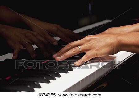 Stock Photography - fort lauderdale, florida, united states of america; hands playing the piano. Fotosearch