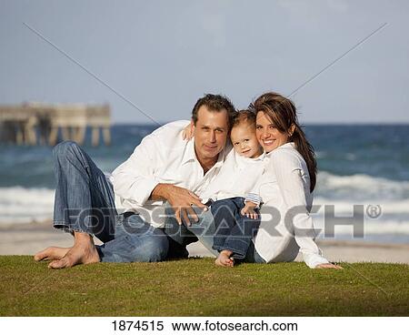 fort lauderdale, florida, united states of america; a family sitting on the grass by the ocean View Large Photo Image Stock Photography - fort lauderdale, florida, united states of america; a family sitting on the grass by the ocean. Fotosearch