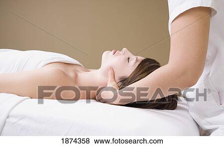getting a neck massage from a massage therapist View Large Photo Image Stock Photo - getting a neck massage from a massage therapist. Fotosearch