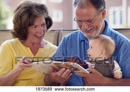 grandparents reading to their grandson View Large Photo Image Stock Photo - grandparents reading to their grandson. Fotosearch