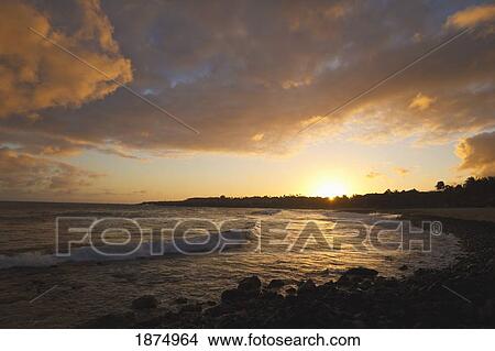 Picture - hawaii, united states of america; dramatic sunset over shipwreck beach and cove with incoming waves. Fotosearch