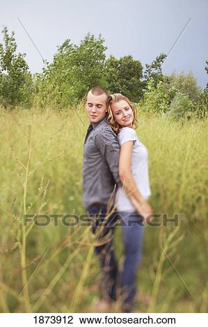 jordan, ontario, canada; a couple standing back to back in a field View Large Photo Image Stock Image - jordan, ontario, canada; a couple standing back to back in a field. Fotosearch