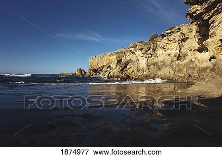 Stock Photo - kauai, hawaii, united states of america; tide pool reflects sea cliffs and sky along the eastern shore of kauai. Fotosearch