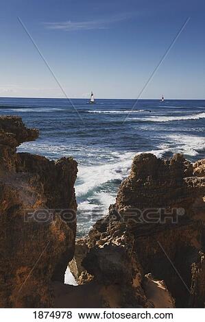 Stock Photo - kauai, hawaii, united states of america; sailboats cruise along rugged coastal formations on the southeastern shore of kauai. Fotosearch