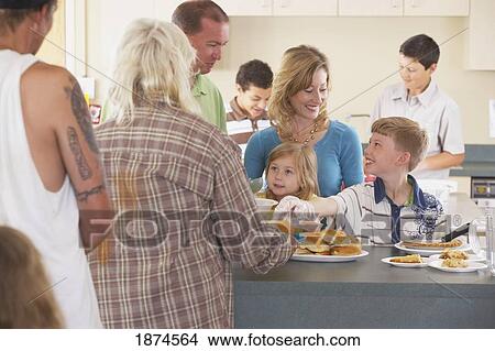 knoxville, tennessee, united states of america; a family serving a meal to those in need View Large Photo Image Picture - knoxville, tennessee, united states of america; a family serving a meal to those in need. Fotosearch
