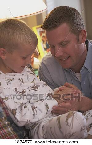Stock Image - knoxville, tennessee, united states of america; a father praying with his son at bedtime. Fotosearch