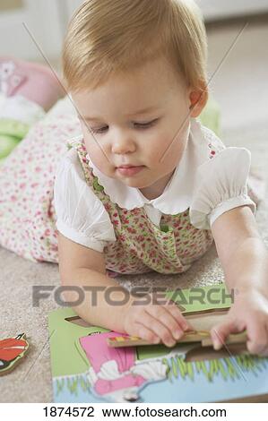 knoxville, tennessee, united states of america; a young girl playing with a wooden puzzle View Large Photo Image Stock Image - knoxville, tennessee, united states of america; a young girl playing with a wooden puzzle. Fotosearch