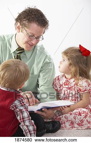 knoxville, tennessee, united states of america; a man teaches a bible story to two young children View Large Photo Image Stock Image - knoxville, tennessee, united states of america; a man teaches a bible story to two young children. Fotosearch