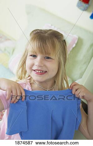knoxville, tennessee, united states of america; a girl holding up a shirt in front of her View Large Photo Image Stock Photo - knoxville, tennessee, united states of america; a girl holding up a shirt in front of her. Fotosearch