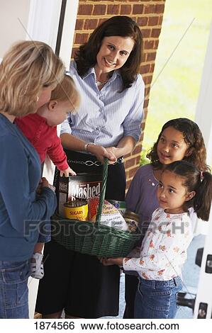 knoxville, tennessee, united states of america; a mother and her daughters delivering a basket of food to a woman with her child View Large Photo Image Stock Photograph - knoxville, tennessee, united states of america; a mother and her daughters delivering a basket of food to a woman with her child. Fotosearch