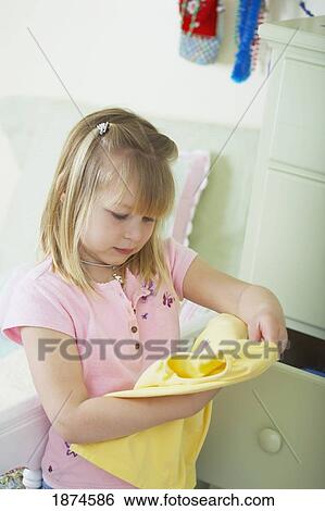 knoxville, tennessee, united states of america; a girl picking out a new shirt from her dresser drawer View Large Photo Image Stock Photograph - knoxville, tennessee, united states of america; a girl picking out a new shirt from her dresser drawer. Fotosearch