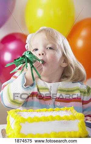 knoxville, tennessee, united states of america; a young girl with balloons and a cake and blowing into a party blower View Large Photo Image Stock Photography - knoxville, tennessee, united states of america; a young girl with balloons and a cake and blowing into a party blower. Fotosearch