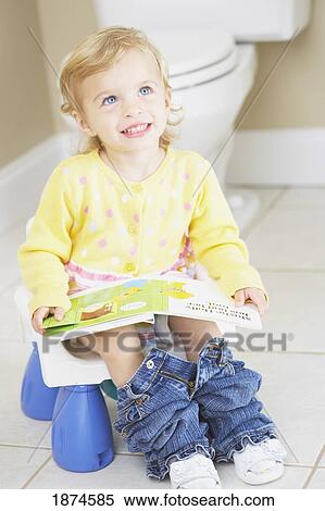 knoxville, tennessee, united states of america; a young child sitting on a child's potty and reading a book View Large Photo Image Stock Photography - knoxville, tennessee, united states of america; a young child sitting on a child's potty and reading a book. Fotosearch
