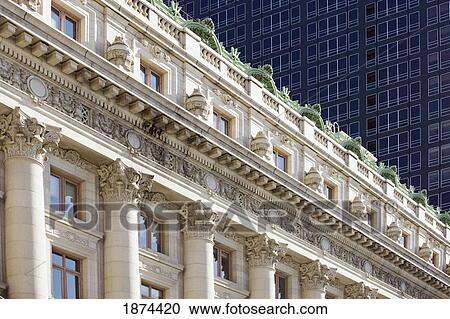 Stock Image - new york, new york, united states of america; an old building in front of a new building. Fotosearch