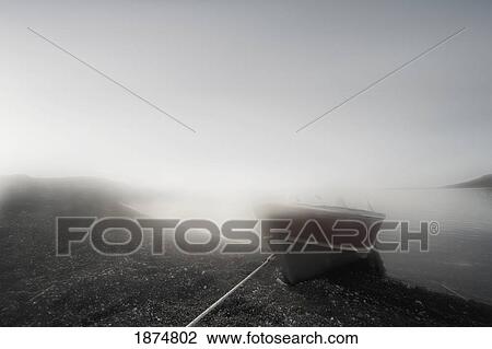 Stock Image - northwest territories, canada; a boat on the shore of the arctic ocean. Fotosearch