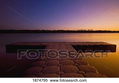 Stock Photography - northwest territories, canada; a pier on mackenzie river at sunset. Fotosearch