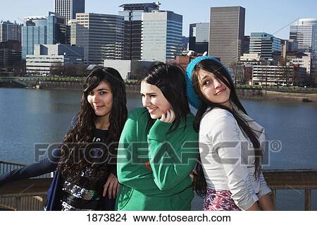 Picture - portland, oregon, united states of america; three teenage girls against the cityscape. Fotosearch
