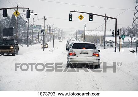 Stock Image - portland, oregon, united states of america; cars driving on the road during a winter storm. Fotosearch