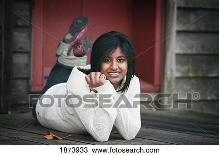 portrait of a young woman laying on a porch View Large Photo Image Stock Image - portrait of a young woman laying on a porch. Fotosearch