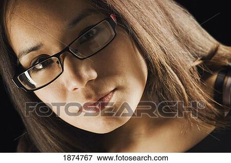 portrait of a young woman wearing eyeglasses View Large Photo Image Stock Photo - portrait of a young woman wearing eyeglasses. Fotosearch